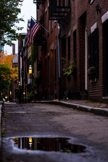 Beacon Hill alleyway with puddle reflection